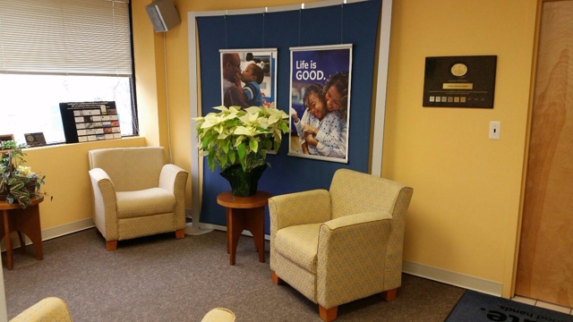 Photo of Cindy Donaldson: Allstate Insurance with customers to explain their policy coverage