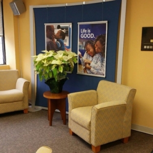 Photo of Cindy Donaldson: Allstate Insurance with customers to explain their policy coverage
