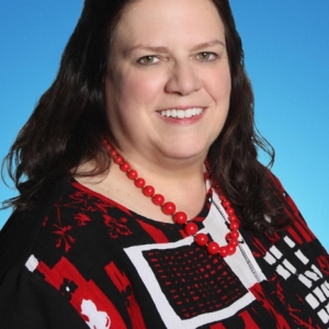 Photo of Cindy Donaldson: Allstate Insurance with customers to explain their policy coverage