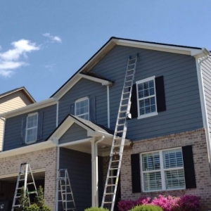 Photo of Zelaya painting and pressure washing